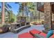 The outdoor living space includes a stone fireplace, outdoor seating, and lush landscaping at 731 Weston Rd, Larkspur, CO 80118