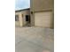 Driveway with attached one car garage on a tan home at 13349 W Alameda W Pkwy # 102, Lakewood, CO 80228