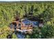 Captivating aerial perspective of a house embraced by a dense forest, highlighting its secluded and peaceful location at 18680 Arrowwood Dr, Monument, CO 80132