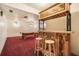 Basement bar area with custom woodworking and stools at 18680 Arrowwood Dr, Monument, CO 80132