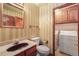 Cozy bathroom and laundry room with stylish vanity, toilet, and laundry machines at 18680 Arrowwood Dr, Monument, CO 80132