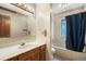 Bathroom features a tub shower, vanity, and ample lighting at 18680 Arrowwood Dr, Monument, CO 80132