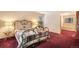 Comfortable bedroom with plush carpet and access to an en-suite bathroom with bright lighting at 18680 Arrowwood Dr, Monument, CO 80132