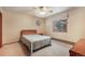 Cozy bedroom with window, ceiling fan, patterned quilt, and carpet at 18680 Arrowwood Dr, Monument, CO 80132