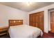 Bedroom featuring a large bed, wooden closet doors and neutral walls creating a serene environment at 18680 Arrowwood Dr, Monument, CO 80132
