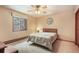 Bright bedroom features a ceiling fan, spacious closet and scenic window view at 18680 Arrowwood Dr, Monument, CO 80132