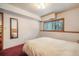 Bedroom with a large window and neutral walls creating a serene environment at 18680 Arrowwood Dr, Monument, CO 80132