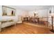 Open-concept dining room with hardwood floors and stylish chandelier, adjacent to stairs and living space at 18680 Arrowwood Dr, Monument, CO 80132