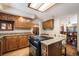 Kitchen featuring granite countertops, wood cabinetry, and a breakfast bar with seating, open to the dining area at 18680 Arrowwood Dr, Monument, CO 80132