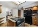Well-equipped kitchen with granite countertops, wood cabinets, and a center island with cooktop and seating at 18680 Arrowwood Dr, Monument, CO 80132