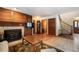 Warm living room with hardwood floors, fireplace and a staircase leading up to the second story at 18680 Arrowwood Dr, Monument, CO 80132