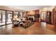 Spacious living room with hardwood floors, a fireplace, large windows, and sliding glass doors at 18680 Arrowwood Dr, Monument, CO 80132