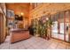 Bright sunroom with wood paneling, tile floor, and hot tub with snowy views from ample windows at 18680 Arrowwood Dr, Monument, CO 80132