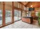 Bright sunroom with hot tub and large windows offering views of snow-covered landscape at 18680 Arrowwood Dr, Monument, CO 80132