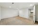 Partially finished basement with carpet and vinyl flooring, offering versatility at 1050 S Monaco Pkwy # 125, Denver, CO 80224