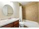 Traditional bathroom features a single vanity, large mirror, and a shower-tub combination with tile surround at 1050 S Monaco Pkwy # 125, Denver, CO 80224