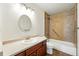 Bathroom with vanity sink, tub, and tiled shower, offering functionality and comfort at 1050 S Monaco Pkwy # 125, Denver, CO 80224