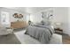 Comfortable bedroom features neutral colors, modern art, a large bed, an area rug and a window with natural light at 1050 S Monaco Pkwy # 125, Denver, CO 80224