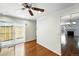 Bright dining area showcasing hardwood floors, a sliding glass door to the backyard, and an adjacent living room at 1050 S Monaco Pkwy # 125, Denver, CO 80224