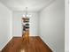 Cozy dining area features hardwood floors, a stylish chandelier, and an open view into the adjacent kitchen at 1050 S Monaco Pkwy # 125, Denver, CO 80224