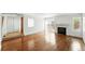 Spacious living room featuring hardwood floors and a fireplace at 1050 S Monaco Pkwy # 125, Denver, CO 80224