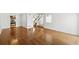 Open-concept living room boasts gleaming hardwood floors, natural light, and a staircase leading to the upper level at 1050 S Monaco Pkwy # 125, Denver, CO 80224