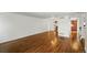 Expansive living room with rich hardwood flooring, neutral walls, and a seamless flow into the adjacent kitchen area at 1050 S Monaco Pkwy # 125, Denver, CO 80224