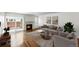 Bright living room with a fireplace, hardwood floors and sliding door access to outdoor space at 1050 S Monaco Pkwy # 125, Denver, CO 80224
