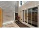 Outdoor patio with wooden deck and small grill; perfect for summer barbecues at 1050 S Monaco Pkwy # 125, Denver, CO 80224