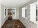 Covered front porch area with wood flooring at 1050 S Monaco Pkwy # 125, Denver, CO 80224