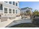 Inviting back patio with ample seating area, outdoor fire pit, string lights, and stone accents at 21854 Tyrolite Ave, Parker, CO 80138