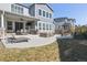 Expansive back patio with a seating area, fire pit, lounge chair, and covered patio with outdoor dining set at 21854 Tyrolite Ave, Parker, CO 80138