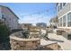 Beautiful backyard patio with a fire pit, outdoor seating, and string lights for evening gatherings at 21854 Tyrolite Ave, Parker, CO 80138