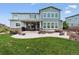 Large back patio, outdoor furniture and a well-manicured lawn, perfect for entertaining at 21854 Tyrolite Ave, Parker, CO 80138