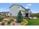 Landscaped backyard with lush greenery and a stone patio seating area at 21854 Tyrolite Ave, Parker, CO 80138