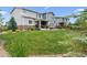 Beautifully landscaped backyard with lush green lawn and stone trim at 21854 Tyrolite Ave, Parker, CO 80138