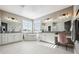 Luxurious bathroom with double vanities, a soaking tub, and modern lighting fixtures at 21854 Tyrolite Ave, Parker, CO 80138