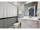 Charming bathroom with a black-and-white shower curtain and classic fixtures at 21854 Tyrolite Ave, Parker, CO 80138