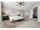 Stylish bedroom with a ceiling fan, large windows, and a calming color scheme at 21854 Tyrolite Ave, Parker, CO 80138