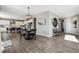 Open floor plan featuring a modern dining area and kitchen with white cabinetry at 21854 Tyrolite Ave, Parker, CO 80138