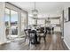 Dining area with sliding glass doors, stylish lighting, and access to outdoor patio at 21854 Tyrolite Ave, Parker, CO 80138