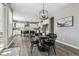 Bright dining area with a round table, black chairs, and a view into the modern kitchen at 21854 Tyrolite Ave, Parker, CO 80138