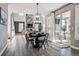 Open-concept dining area adjacent to a living room with a stone fireplace and outdoor patio at 21854 Tyrolite Ave, Parker, CO 80138