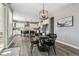 Bright dining room with a round table, chairs and a clear view of the open-concept kitchen at 21854 Tyrolite Ave, Parker, CO 80138