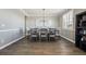 Elegant dining area with a large table, stylish decor, and hardwood flooring at 21854 Tyrolite Ave, Parker, CO 80138