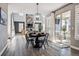 Elegant dining room with a round table, chairs, and seamless flow into the living area at 21854 Tyrolite Ave, Parker, CO 80138