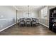 Elegant dining room featuring hardwood floors and a large dining table set for eight at 21854 Tyrolite Ave, Parker, CO 80138