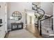 Elegant entryway featuring hardwood floors, a curved staircase, and stylish decor at 21854 Tyrolite Ave, Parker, CO 80138