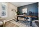 Comfortable home office featuring a wood desk, chair, accent rug, and a wall with decorative art at 21854 Tyrolite Ave, Parker, CO 80138
