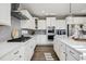 Modern kitchen with white cabinets, granite countertops, stainless steel appliances, and a gas range at 21854 Tyrolite Ave, Parker, CO 80138